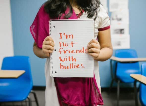 Girl Carrying a Board- I m not friends with bullies